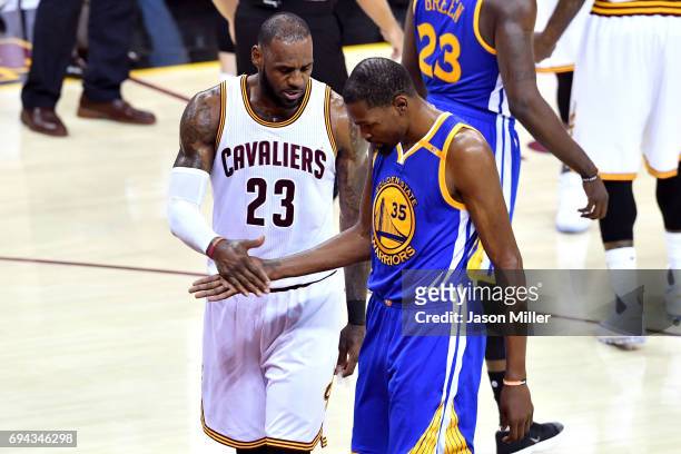LeBron James of the Cleveland Cavaliers and Kevin Durant of the Golden State Warriors react in the third quarter in Game 4 of the 2017 NBA Finals at...