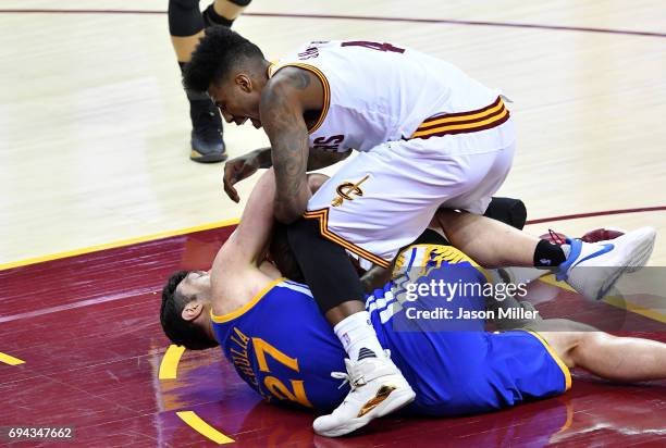 Iman Shumpert of the Cleveland Cavaliers compete for the ball with Zaza Pachulia of the Golden State Warriors in the third quarter in Game 4 of the...