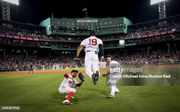 Mookie Betts and Andrew Benintendi react as Jackie Bradley Jr. #19 does the "ski jump" to celebrate his ninth inning home run and a 5-3 win over the...