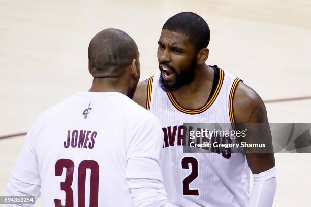 Kyrie Irving of the Cleveland Cavaliers celebrates with Dahntay Jones after a play in the fourth quarter against the Golden State Warriors in Game 4...