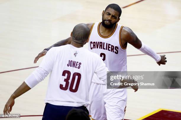 Kyrie Irving of the Cleveland Cavaliers celebrates with Dahntay Jones after a play in the fourth quarter against the Golden State Warriors in Game 4...