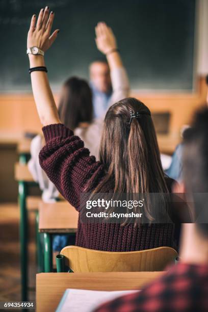 rear view of high school students with raised arm. - edifício de escola secundária imagens e fotografias de stock