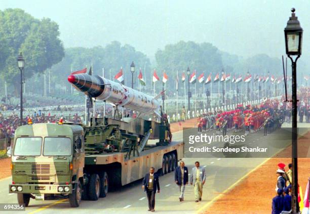 Plain clothes policemen accompany a carrier mounted with an "Agni-II" Inter-Continental Ballistic Missile during a full dress rehearsal for Indias...