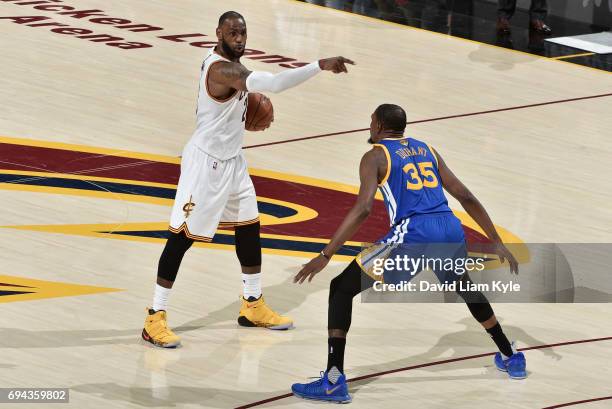 LeBron James of the Cleveland Cavaliers directs his teammates against Kevin Durant of the Golden State Warriors in Game Four of the 2017 NBA Finals...