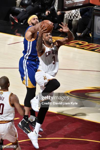 Derrick Williams of the Cleveland Cavaliers goes up for the shot against JaVale McGee of the Golden State Warriors in Game Four of the 2017 NBA...