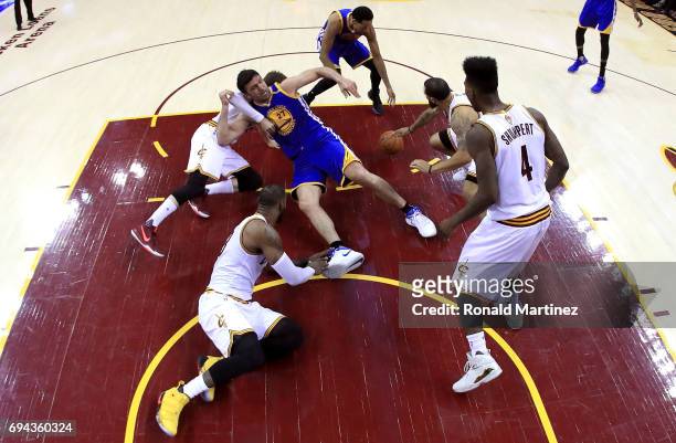 Zaza Pachulia of the Golden State Warriors gets tangled with Kyle Korver and Deron Williams of the Cleveland Cavaliers as LeBron James and Iman...