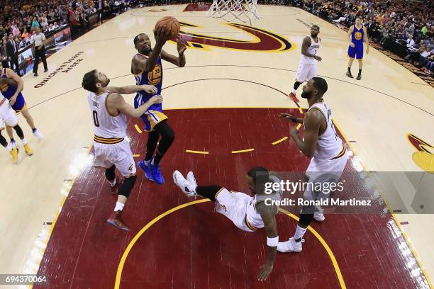 Kevin Durant of the Golden State Warriors drives to the basket against Kevin Love of the Cleveland Cavaliers in the second half in Game 4 of the 2017...