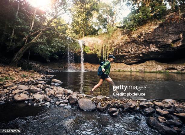 just a few more steps to the waterfall - waterfall-jump stock pictures, royalty-free photos & images