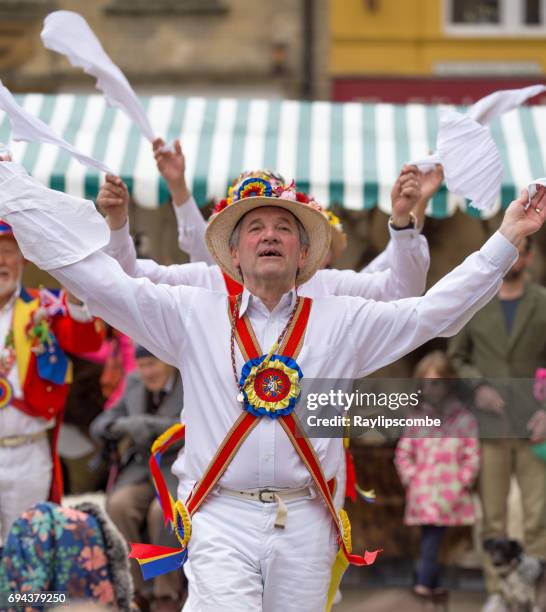 the gloucestershire morris men performing a traditional dance at the fleece fair in cirencester market place - morris dancer stock pictures, royalty-free photos & images