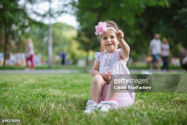 playing while sitting on a potty - girls peeing stock pictures, royalty-free photos & images