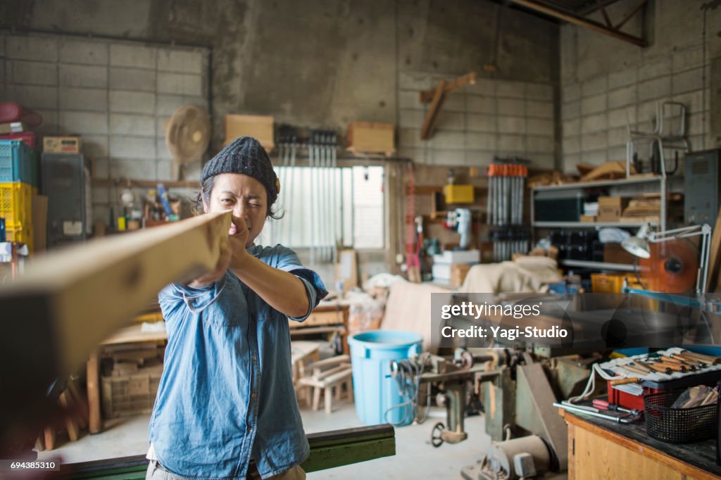 Female craftsperson working in woodworking studio