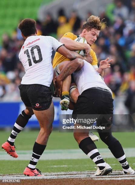 Michael Hooper of the Wallabies is tackled by Ben Volavola of Fiji during the International Test match between the Australian Wallabies and Fiji at...