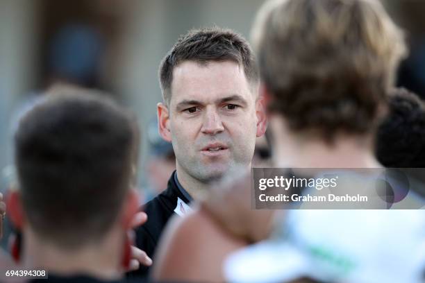 Collingwood VFL Coach Jared Rivers talks to his players during the round eight VFL match between Casey Demons and Collingwood Magpies at Casey Fields...