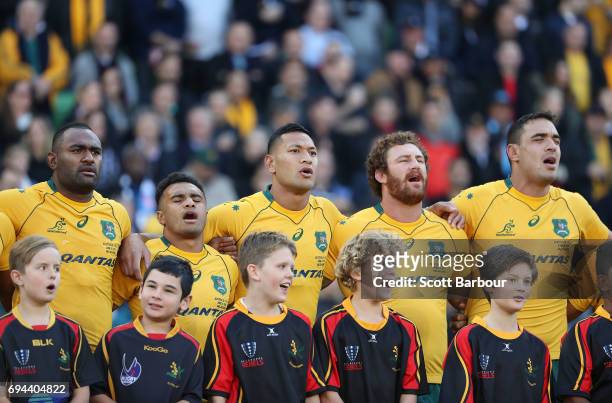 Israel Folau, Will Genia, Scott Higginbotham and the Wallabies stand for the national anthem during the International Test match between the...