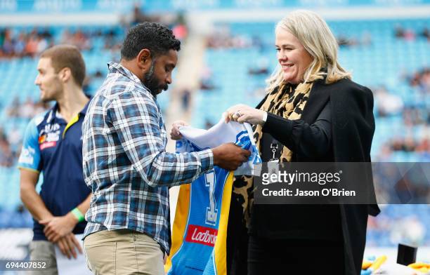 Preston Campbell receives a jersey from Rebecca Frizelle during the round 14 NRL match between the Gold Coast Titans and the New Zealand Warriors at...