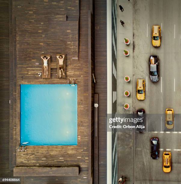 coouple on a new york city rooftop. image composition. - on top of car stock pictures, royalty-free photos & images