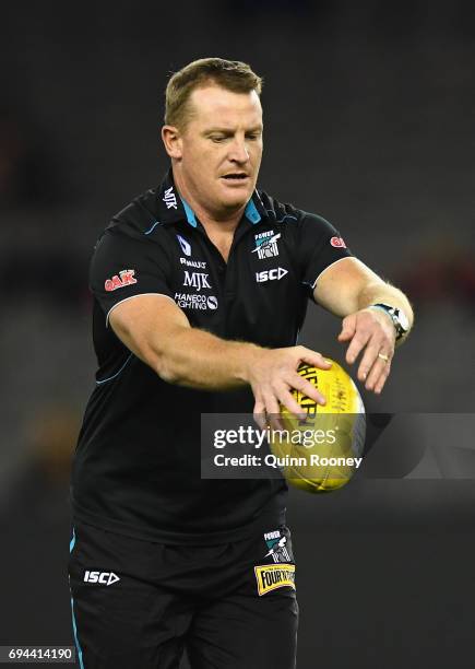 Power assistant coach Michael Voss passes the ball during the round 12 AFL match between the Essendon Bombers and the Port Adelaide Power at Etihad...