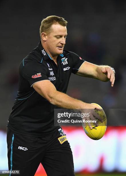 Power assistant coach Michael Voss passes the ball during the round 12 AFL match between the Essendon Bombers and the Port Adelaide Power at Etihad...