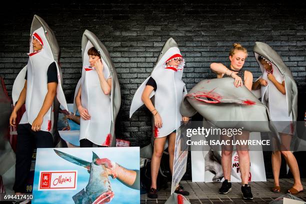 Shark fin activist puts a shark suit on to protest Maxim's flag ship restaurant 'Maxim's Palace', the largest Chinese restaurant group, for selling...