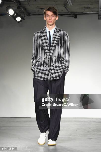 Model walks the runway at the E.Tautz show during the London Fashion Week Men's June 2017 collections on June 10, 2017 in London, England.