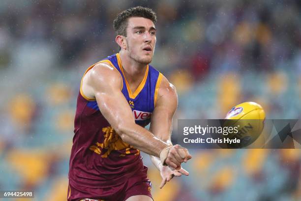Daniel McStay of the Lions handballs during the round 12 AFL match between the Brisbane Lions and the Fremantle Dockers at The Gabba on June 10, 2017...