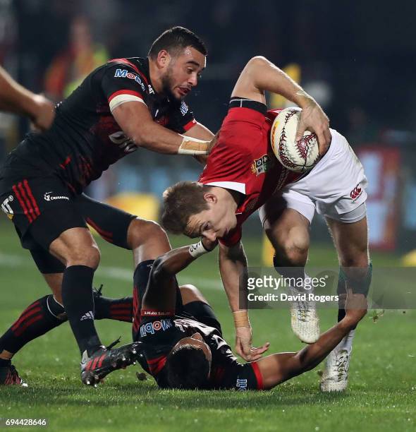Liam Williams of the Lions is tackled by Richie Mounga and Bryn Hall during the match between the Crusaders and the British & Irish Lions at AMI...