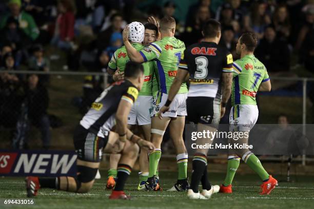 Nick Cotric of the Raiders celebrates with his team mates after scoring a try during the round 14 NRL match between the Penrith Panthers and the...