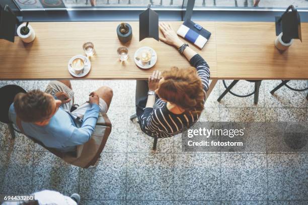 man and woman drinking coffee - casual clothing store stock pictures, royalty-free photos & images