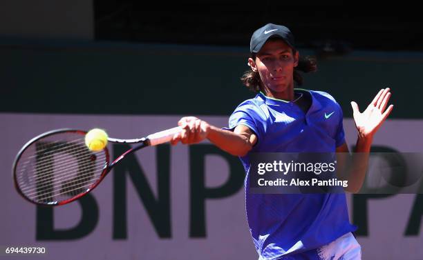 Alexei Popyrin of Australia plays a forehand during the boys singles final match against Nicola Kuhn of Spain on day fourteen of the 2017 French Open...