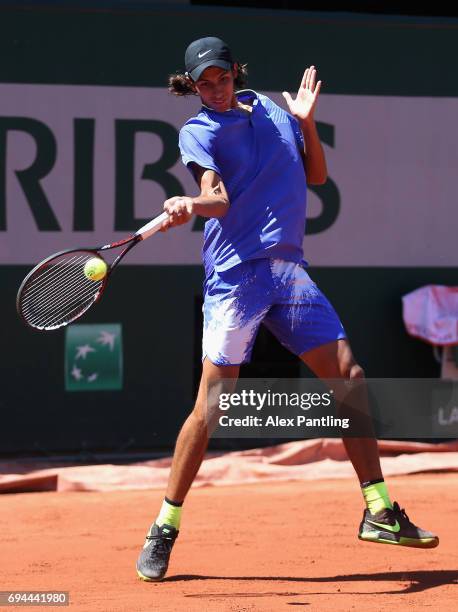 Alexei Popyrin of Australia plays a forehand during the boys singles final match against Nicola Kuhn of Spain on day fourteen of the 2017 French Open...