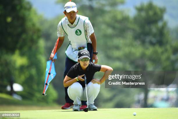 Hee-Kyung Bae of South Korea lines up during the third round of the Suntory Ladies Open at the Rokko Kokusai Golf Club on June 10, 2017 in Kobe,...