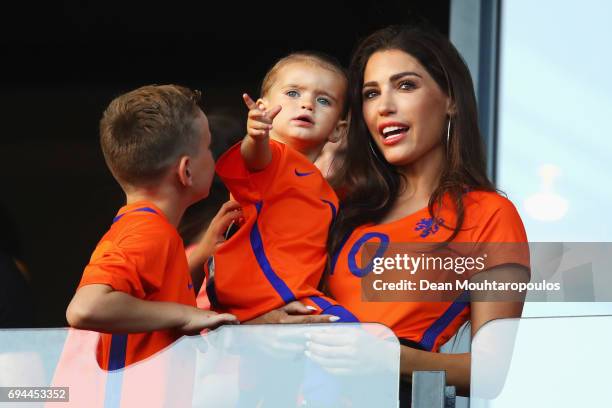 Wesley Sneijder of the Netherlands partner, Yolanthe Sneijder-Cabau and his children watch from the stands during the FIFA 2018 World Cup Qualifier...