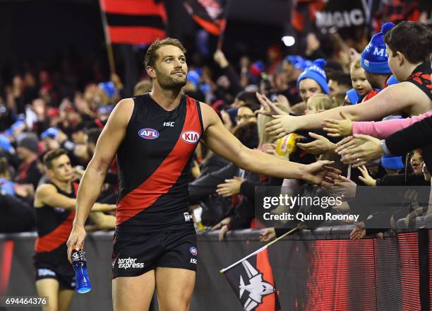 Tom Bellchambers of the Bombers high fives fans after winning the round 12 AFL match between the Essendon Bombers and the Port Adelaide Power at...