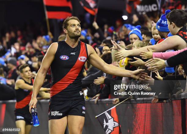 Tom Bellchambers of the Bombers high fives fans after winning the round 12 AFL match between the Essendon Bombers and the Port Adelaide Power at...