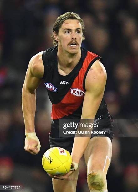 Joe Daniher of the Bombers handballs during the round 12 AFL match between the Essendon Bombers and the Port Adelaide Power at Etihad Stadium on June...