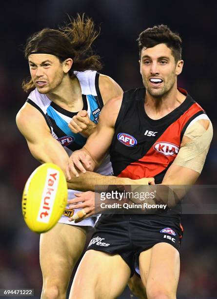 Jasper Pittard of the Power and David Myers of the Bombers compete for the ball during the round 12 AFL match between the Essendon Bombers and the...