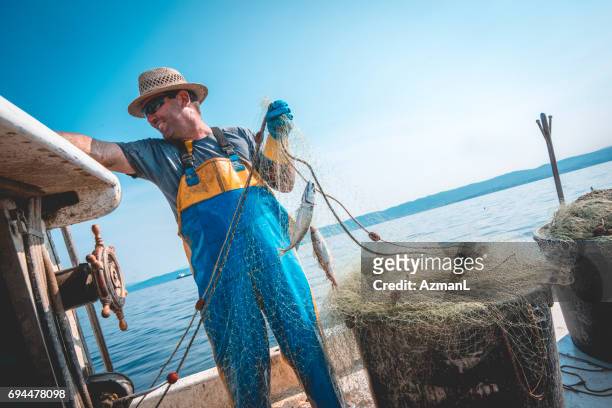happy fisherman - nautical equipment stock pictures, royalty-free photos & images