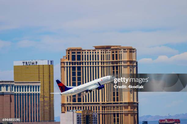 las vegas hotel casino buildings with airplane taking off in the foreground - aeromexico stock pictures, royalty-free photos & images