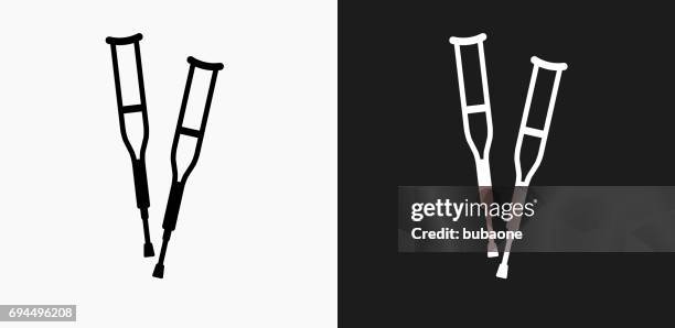 crutches icon on black and white vector backgrounds - crutches stock illustrations