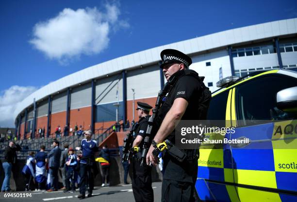 Armed police officers are seen outside the stadium prior to the FIFA 2018 World Cup Qualifier between Scotland and England at Hampden Park National...