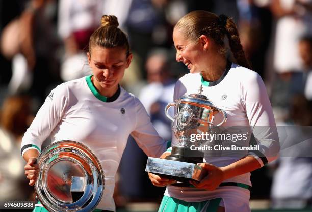 Winner, Jelena Ostapenko of Latvia and Runner up, Simona Halep of Romania share a joke as they hold their trophies following the ladies singles final...