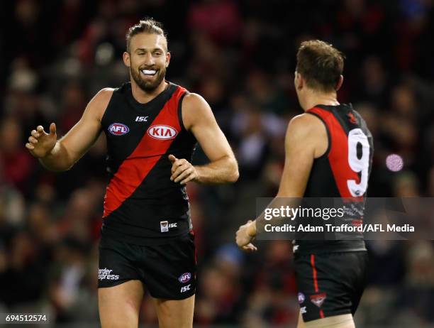 Cale Hooker of the Bombers celebrates a goal with Brendon Goddard of the Bombers during the 2017 AFL round 12 match between the Essendon Bombers and...