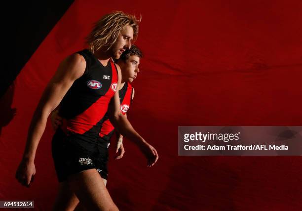 Dyson Heppell and Zach Merrett of the Bombers come up the race during the 2017 AFL round 12 match between the Essendon Bombers and the Port Adelaide...