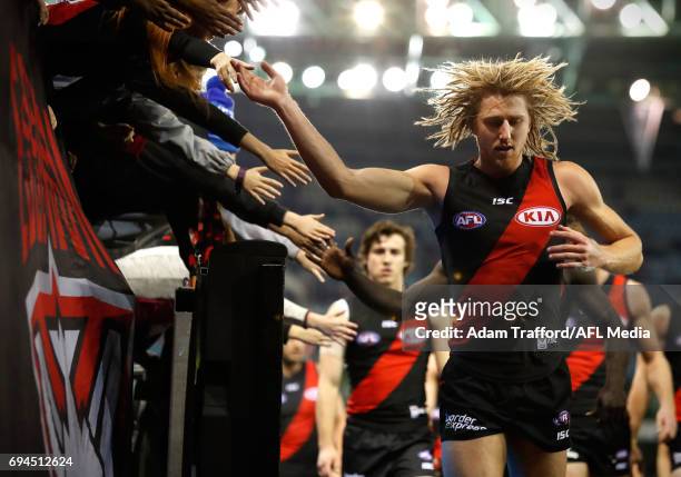 Dyson Heppell of the Bombers leads the team off the field at half time during the 2017 AFL round 12 match between the Essendon Bombers and the Port...
