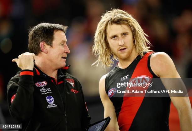 John Worsfold, Senior Coach of the Bombers chats to Dyson Heppell of the Bombers during the 2017 AFL round 12 match between the Essendon Bombers and...