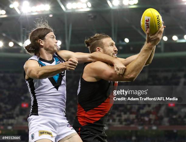 Cale Hooker of the Bombers and Jasper Pittard of the Power compete for the ball during the 2017 AFL round 12 match between the Essendon Bombers and...