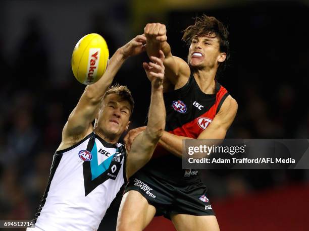 Robbie Gray of the Power and Mark Baguley of the Bombers compete for the ball during the 2017 AFL round 12 match between the Essendon Bombers and the...
