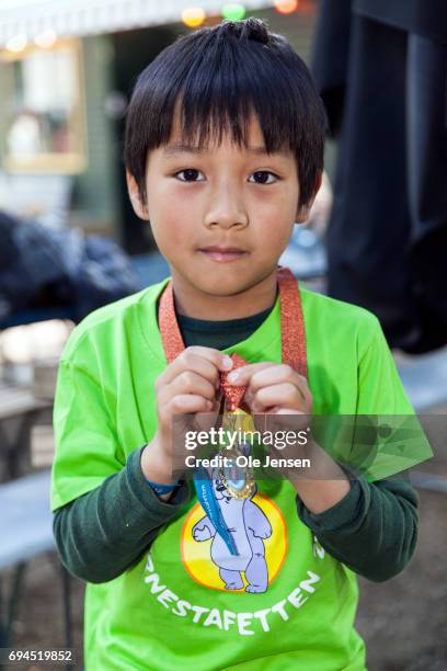 Young Ray Ray, whole lives Oesterbro in Copenhagen, shows proudly his medal which he received by Crown Princess Mary for finishing the 'Children's...