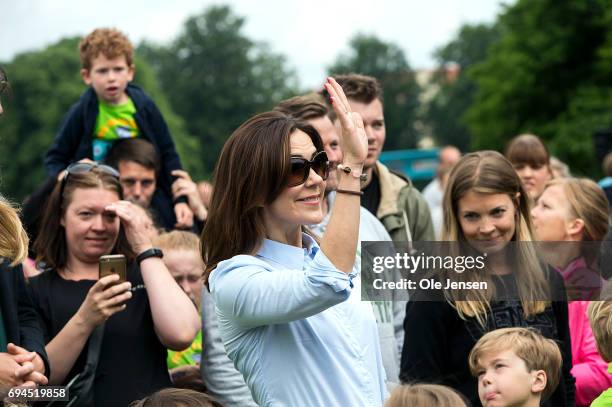 Crown Princess Mary of Denmark waves during the 'Children's Relay Run' in Faelledparken on June 10, 2017 in Copenhagen, Denmark. The kids relay run...