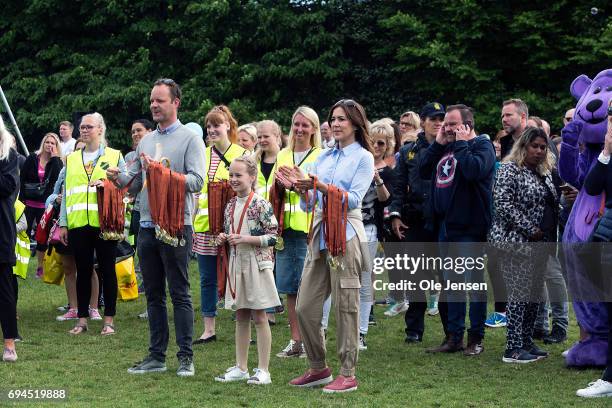 Crown Princess Mary of Denmark with medals around her arm together with Amanda , winner of the Danish Junior European Song Contest 2017, cheer for...